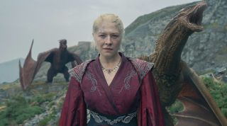 Emma D'arcy as Rhaenyra looking determined with two dragons behind her.