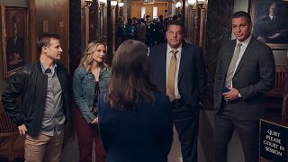 The Blue Bloods cast welcomes back Jennifer Esposito in a hallway scene.