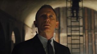 Daniel Craig looking up in curiosity in Skyfall.