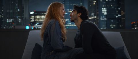 Blake Lively as Lily and Justin Baldoni sitting near each other, looking into each other&#039;s eyes with a skyline behind them.